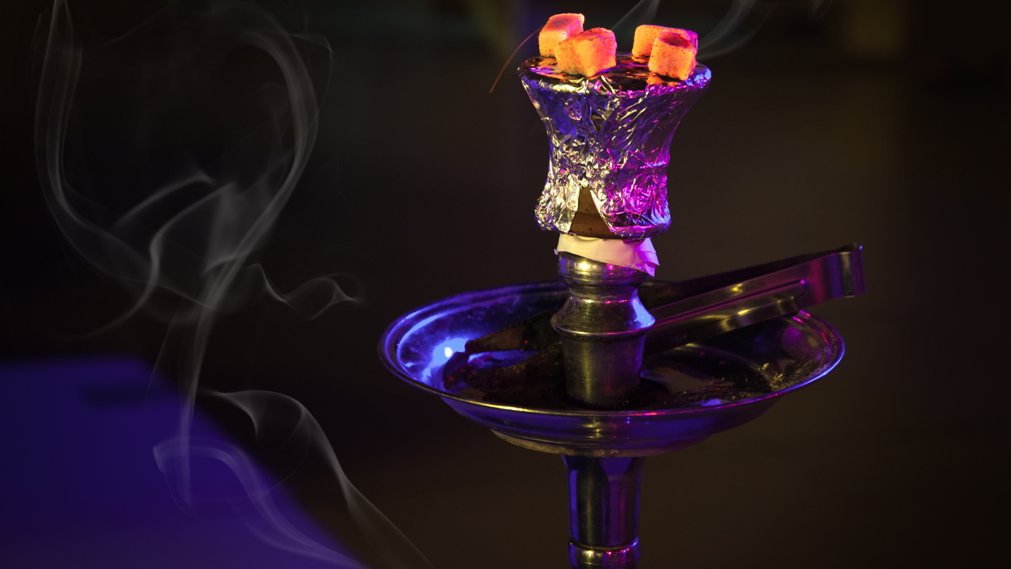 A hookah pipe with lit candles in it