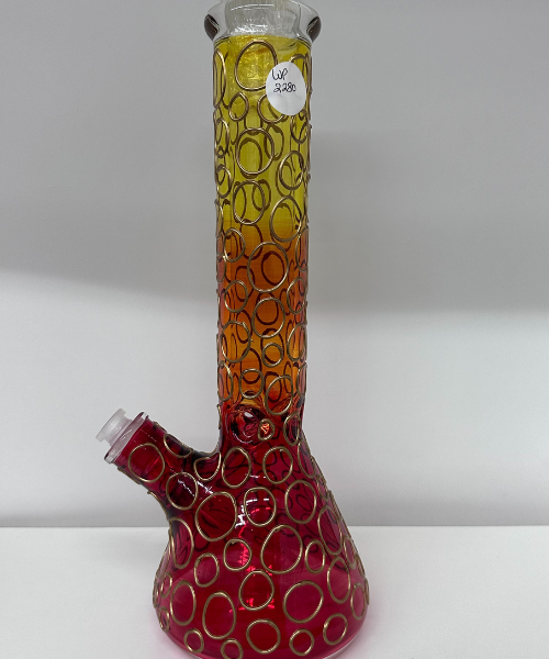 A colorful glass vase with a pipe sticking out of it