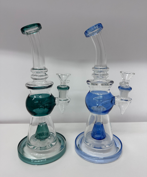 A couple of glass bongs sitting on top of a table